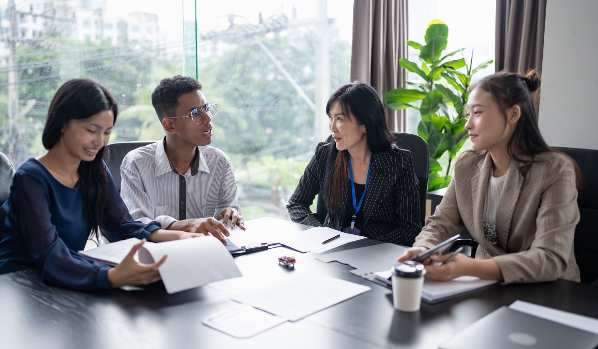 Business meeting with documents and discussion.