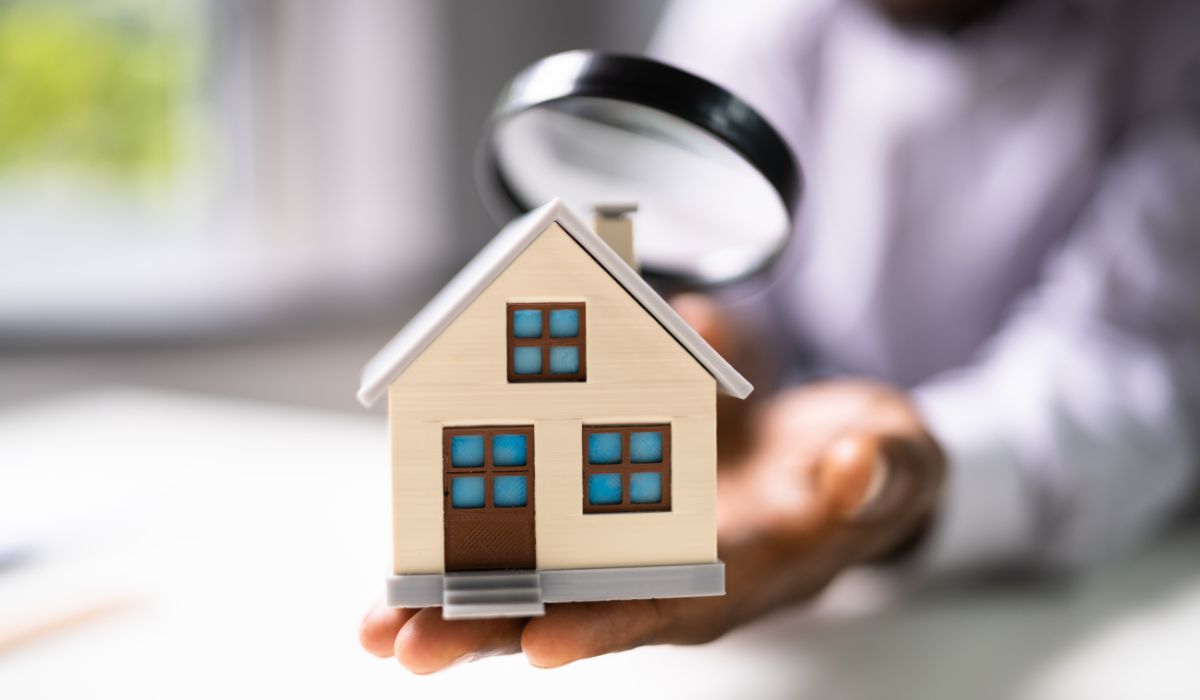 Person inspecting miniature house model